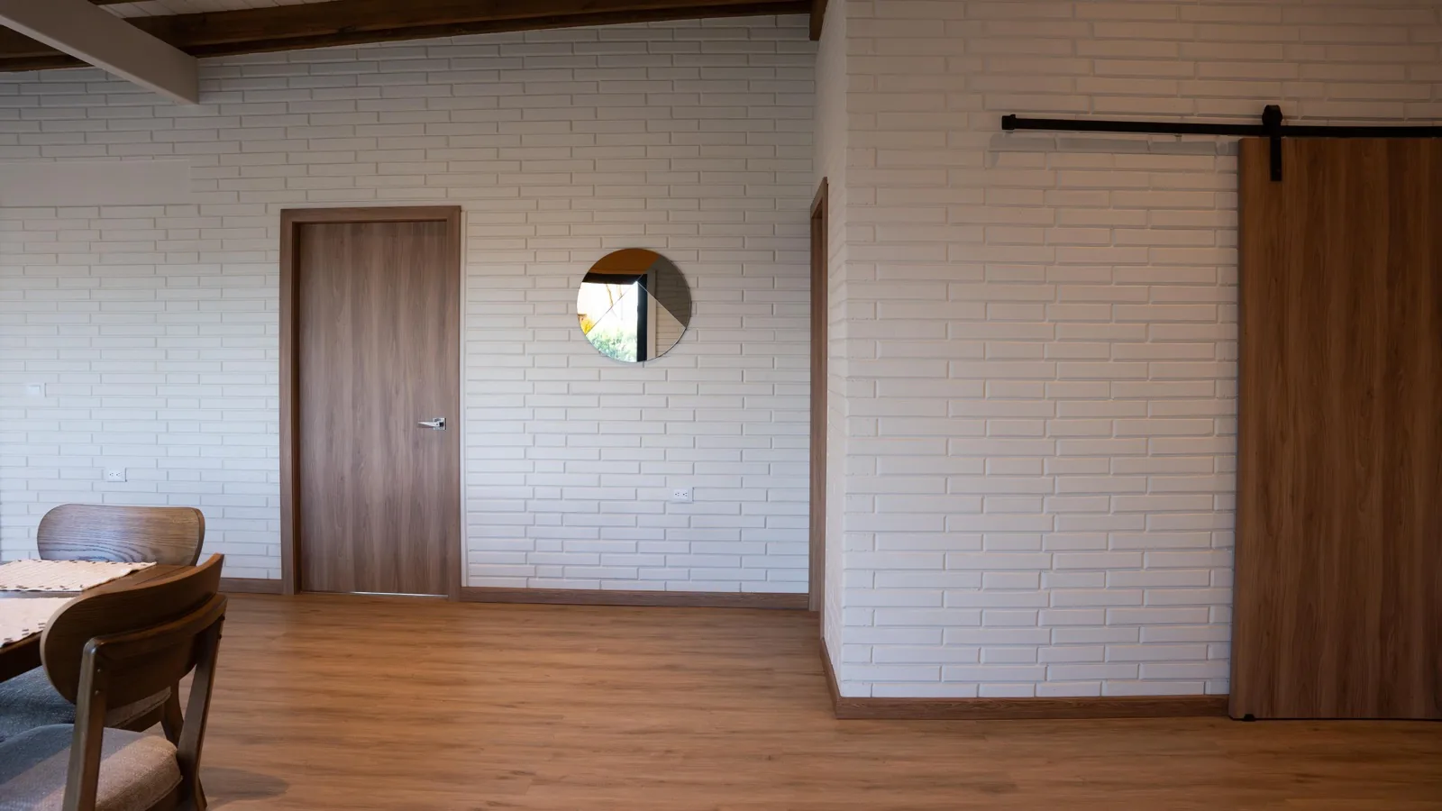 Interior with a round porthole window and sliding barn door