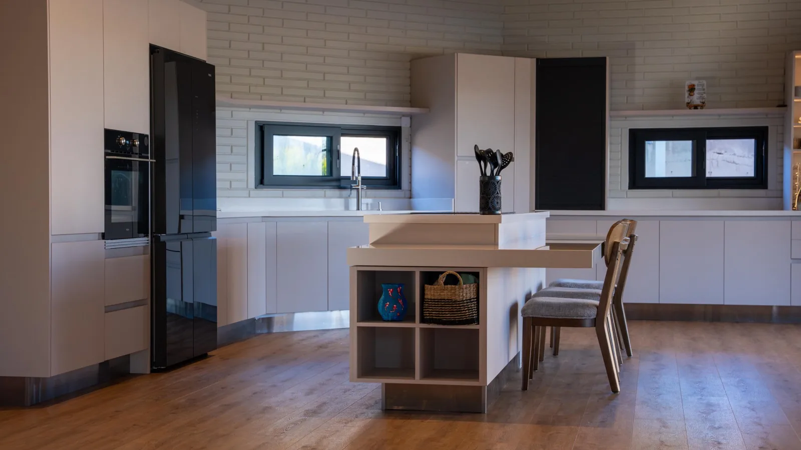 Modern white kitchen with wood island and dining seating