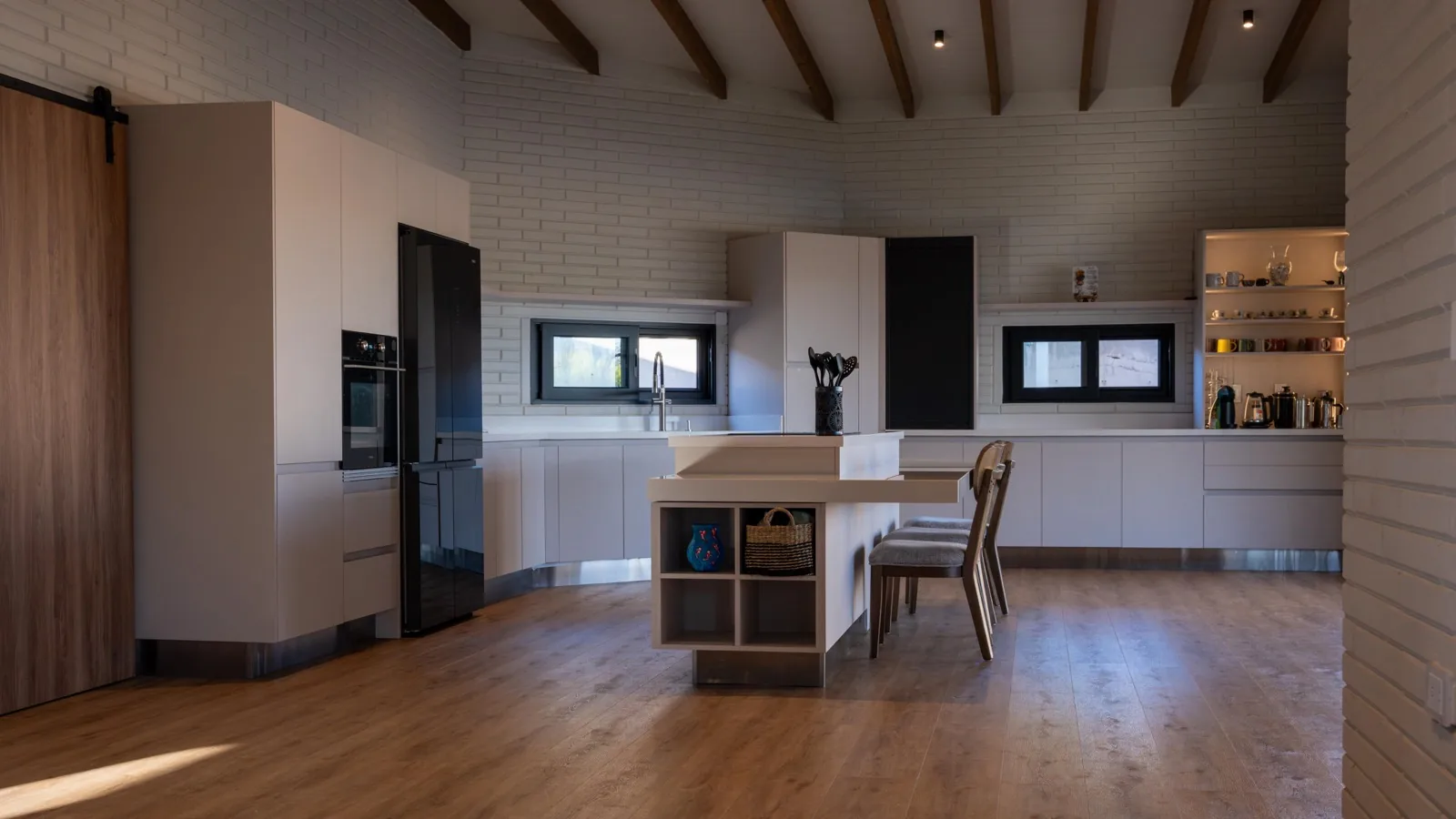 Open-plan kitchen and living space with exposed timber beams